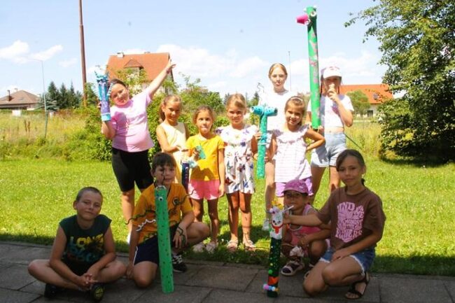 Dzieci w B+CK pozują do zdjęcia ze swoimi pracami plastycznymi