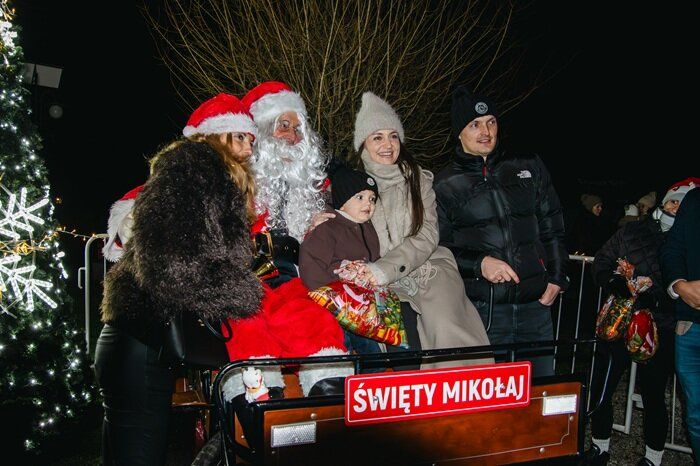 Święty Mikołaj pozuje do zdjęcia z dziećmi